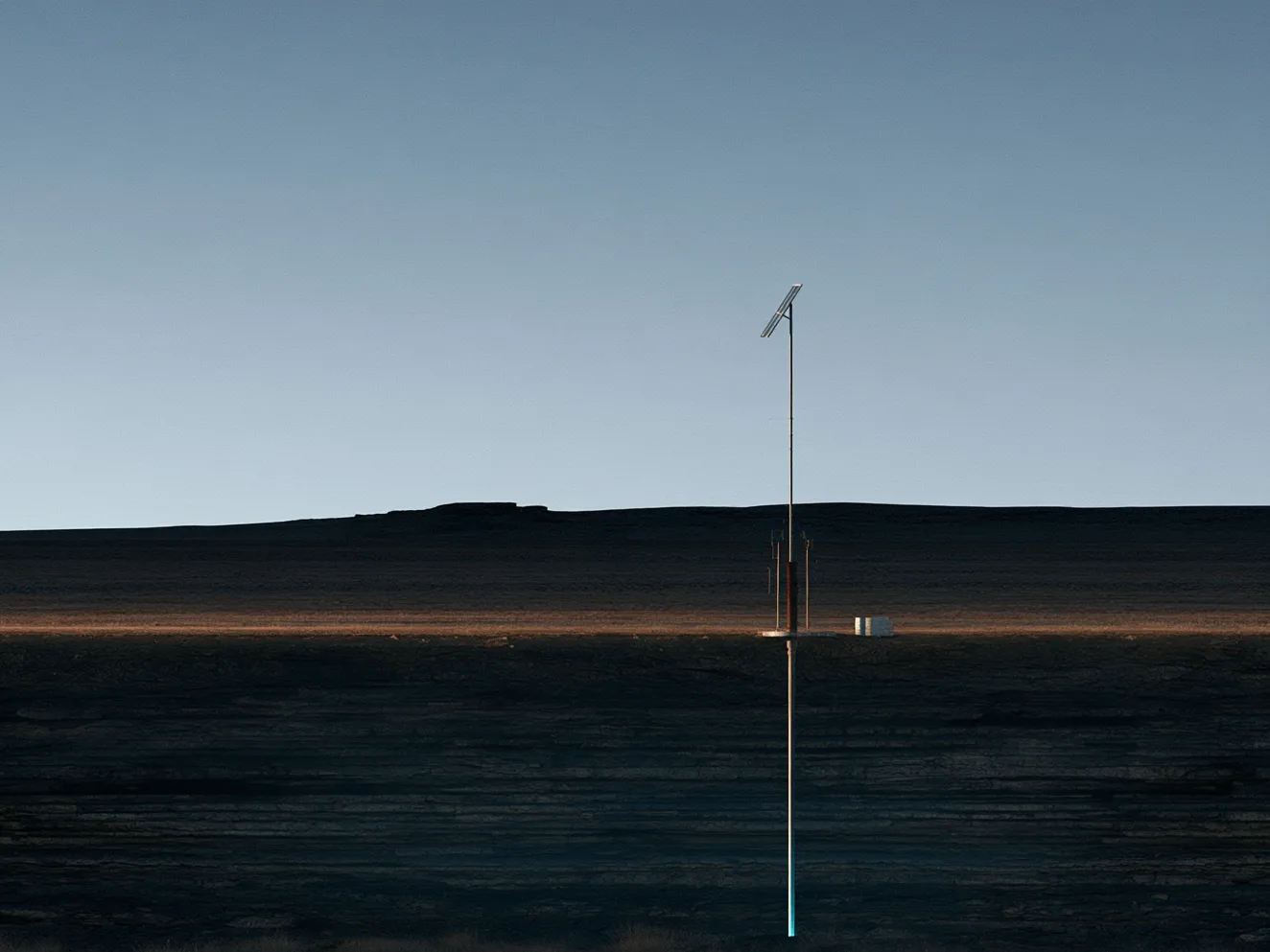 Illustration: a solar-powered monitoring post above a single borehole on open ground at dusk